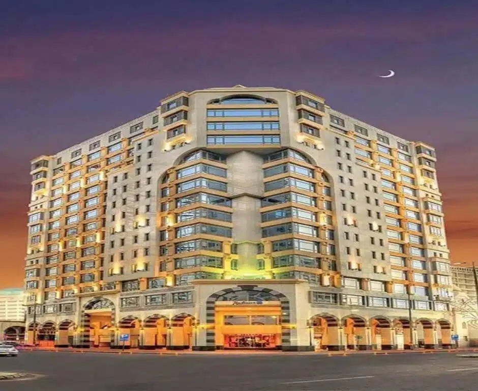 Exterior view of Leader Al Muna Kareem Hotel in Madinah near Masjid An-Nabawi at sunset